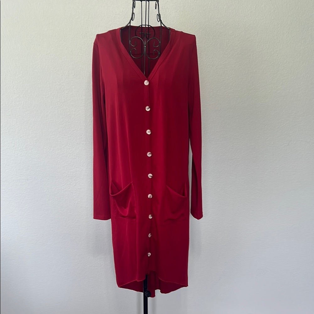Woman’s red button up cardigan with front pockets, stretchy material size medium